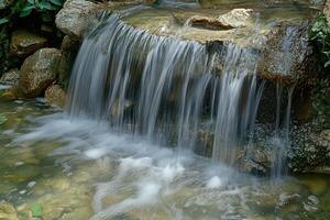 A waterfall in a pond photo