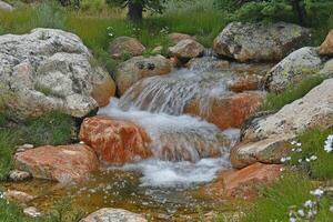 A small stream flowing through a rocky area photo