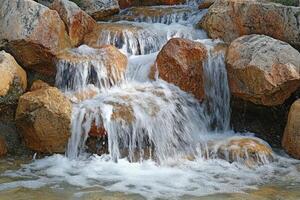 A waterfall flowing over rocks photo