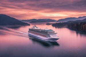 A cruise ship sailing on the water at sunset photo