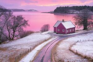 A pink house sits on a snowy hillside near the water photo