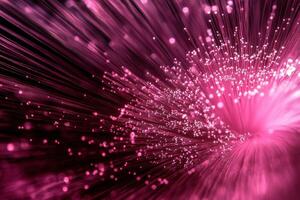 A pink fiber optic cable is shown with a bright light photo