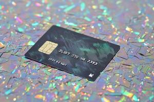 A credit card laying on a glittery surface photo