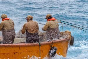 Fishermen in the boat with fishing net photo