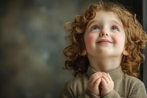 A little girl with curly hair is looking up photo
