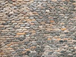 A wall made of stone blocks with a brown and gray color photo