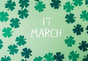 Green background with a bunch of shamrocks and the word March written in white photo