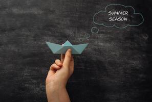 Concept of fun and leisure, as the paper boat is a symbol of childhood memories photo