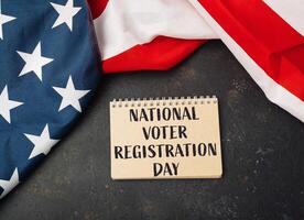 Notebook with the words National Voter Registration Day written on it photo
