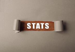 Torn piece of paper with the word stats written on it photo
