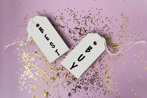 Two tags with the words Best Buy written on them are hanging from a string photo