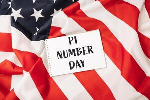 White sign with the word pi written on it is placed on top of a red photo