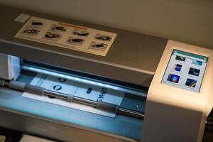 Advanced plotter cutting hydrogel film in a workshop setting for precise design applications photo