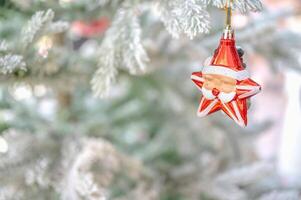 Christmas tree decorated with red and white stars and balls. Selective focus photo