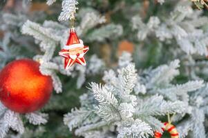 Christmas tree decorated with red and white stars and balls. Selective focus photo