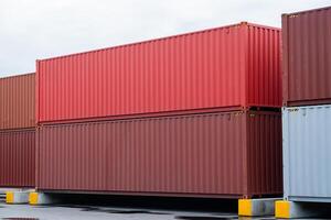 A pile of shipping containers, some of which are red and some are brown. The red containers are stacked on top of the brown containers, creating a visually interesting and dynamic scene photo