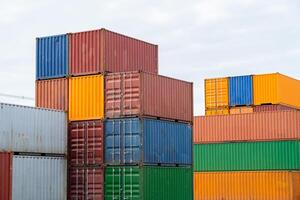 A stack of containers with different colors and sizes. Concept of organization and structure, as the containers are neatly stacked on top of each other. The variety of colors adds visual interest photo