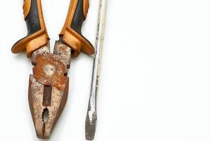Old rusty pliers,screwdriver covered in paint from the home shed for repair photo