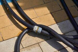 Rubber watering hose with adapter for washing on tiled floors photo