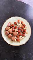 A plate of nuts on a table with a pair of shoes photo