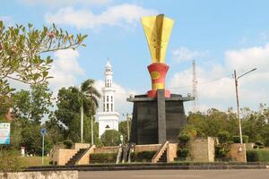 Photo of the welcome monument in Banyuasin Regency with a bright blue sky as a background