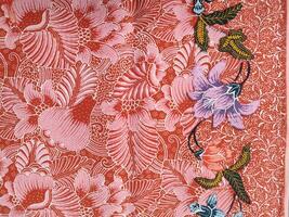 Indonesian batik patterns and backgrounds with images of flowers and leaves in many colors photo