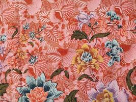 Indonesian batik patterns and backgrounds with images of flowers and leaves in many colors photo