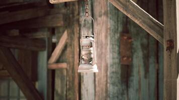Hanging lantern in a rustic wooden setting during daytime light video