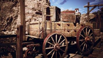 Old wooden cart resting on a rustic dock in a deserted mining town video