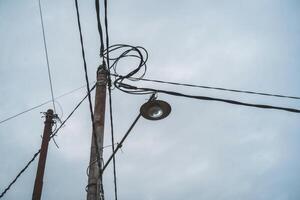 A street light is shown on top of a telephone pole photo