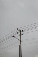A street light is on top of a power pole photo