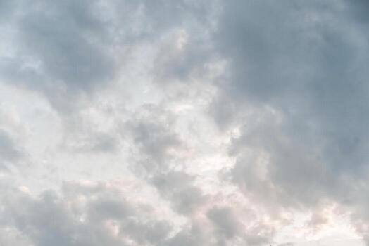 A man is standing on a hill with a kite in the air photo