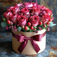 Red roses a round box with a red ribbon photo