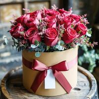 Red roses a round box with a red ribbon photo
