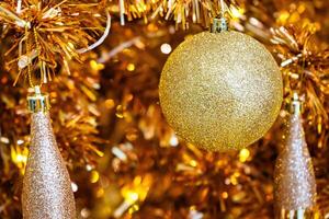 Luxurious Golden Christmas Tree Adorned with Sparkling Ornaments for the Holidays photo