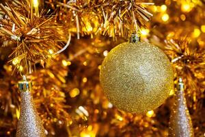 Luxurious Golden Christmas Tree Adorned with Sparkling Ornaments for the Holidays photo