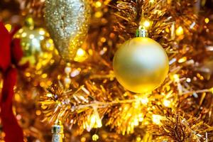 Luxurious Golden Christmas Tree Adorned with Sparkling Ornaments for the Holidays photo