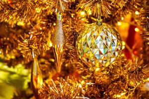 Luxurious Golden Christmas Tree Adorned with Sparkling Ornaments for the Holidays photo