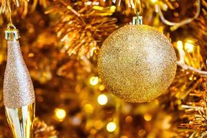 Luxurious Golden Christmas Tree Adorned with Sparkling Ornaments for the Holidays photo