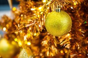 Luxurious Golden Christmas Tree Adorned with Sparkling Ornaments for the Holidays photo
