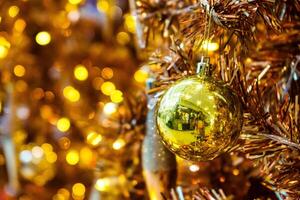 Luxurious Golden Christmas Tree Adorned with Sparkling Ornaments for the Holidays photo