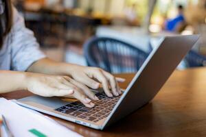 Business woman working from home using laptop online meeting in home office, Closeup image of a woman working and typing on laptop computer keyboard on the table. photo