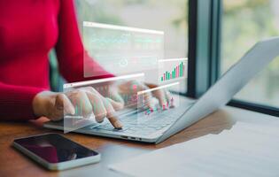 Professional women wearing red sweater working about new startup on laptop to analysis finance of project in outside office, Woman working using laptop online meeting in home office. photo
