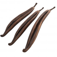 Three aromatic vanilla beans with rich, dark color and unique texture. png