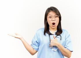 Showing and Presenting Product on Open Palm Of Asian Young Doctor Isolated On White Background photo