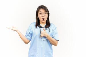 Showing and Presenting Product on Open Palm Of Asian Young Doctor Isolated On White Background photo