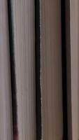 Book shelf's in library. Close up Many books organized in shelves in a big bookstore. The concept of learning, reading, and knowledge. Vertical video