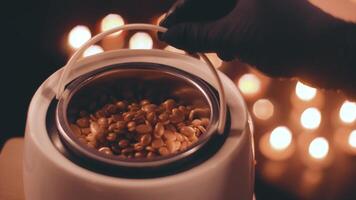 Preparation of gold wax for sugaring. Close-up wax for depilation is heated and melted in a wax melter video