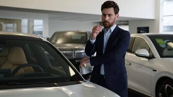 Caucasian man client buyer owner consumer salon buying purchase thinking male guy thoughtful businessman pensive choose choice decision car auto automobile electric transport doubtful ponder business video