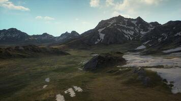 An aerial view of a mountain range with snow on it video